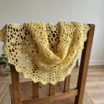Butter yellow shrug draped over a chair