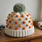 Cozy pumpkin patch hat with bobble pumpkins and green pom pom