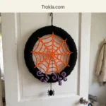 DIY spiderweb Halloween wreath in orange, black and purple
