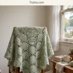 Luna moth lace poncho draped on a chair