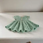 Mint doll dress on a doll stand