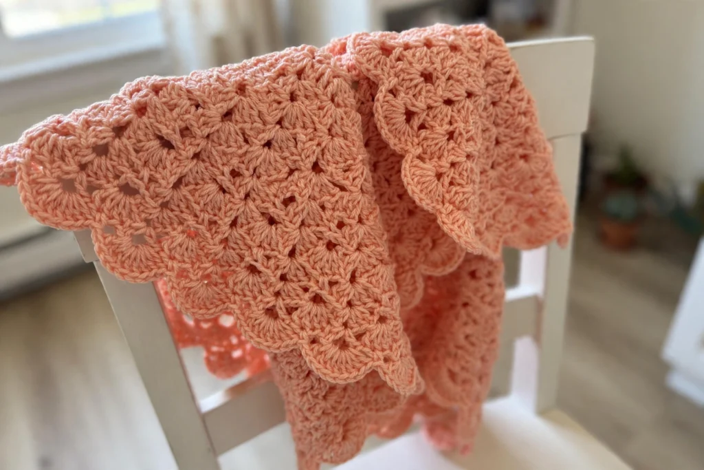 Closeup of peach shell stitches on the poncho