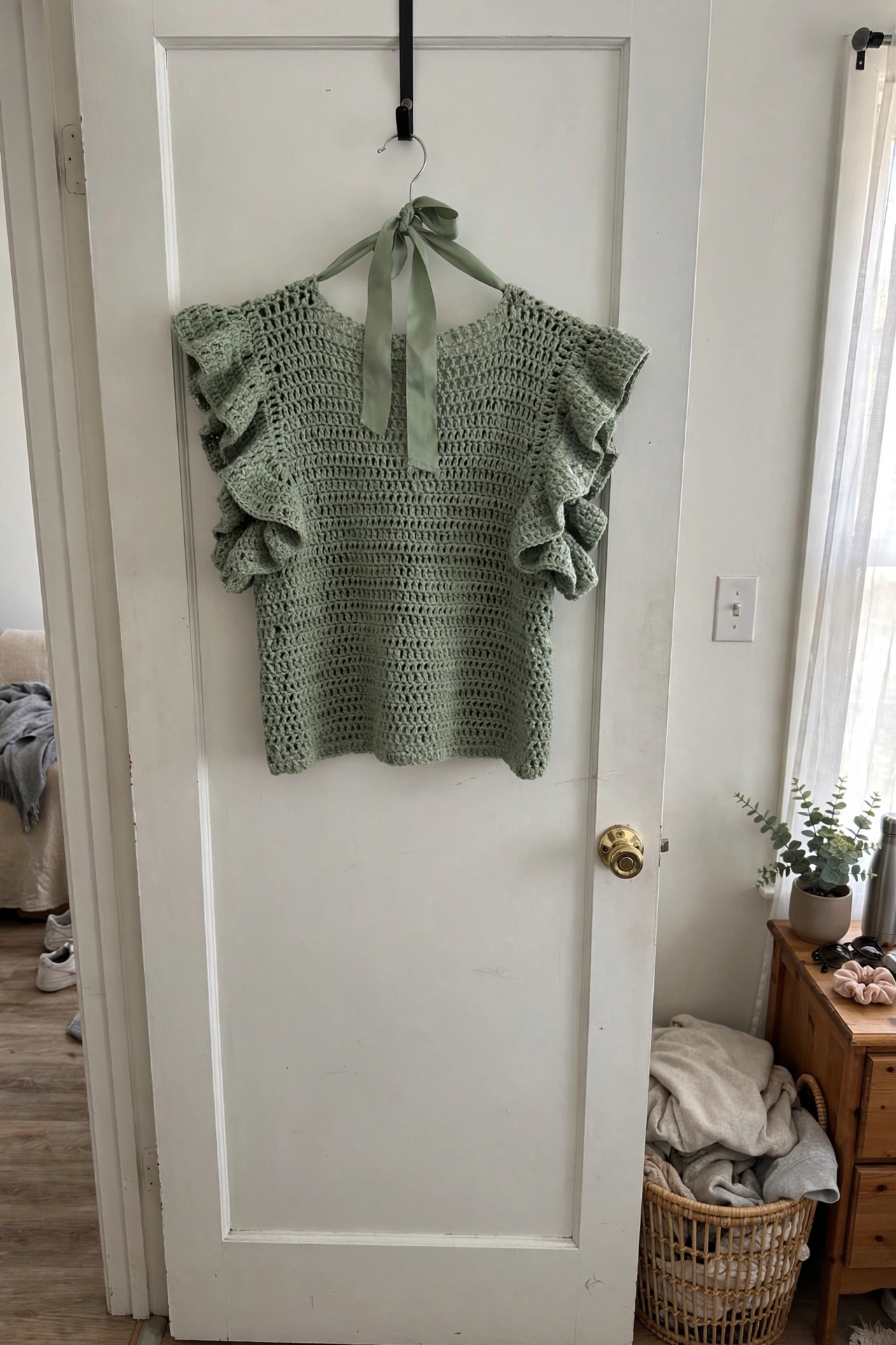 Boho ruffle top styled on a hanger in natural light